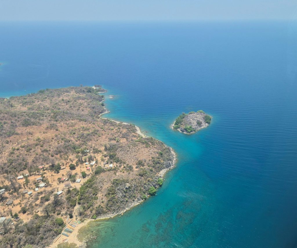 Drone over Malai coast line with blue ocean and island